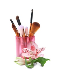 Photo of Holder with makeup brushes of professional artist on white background