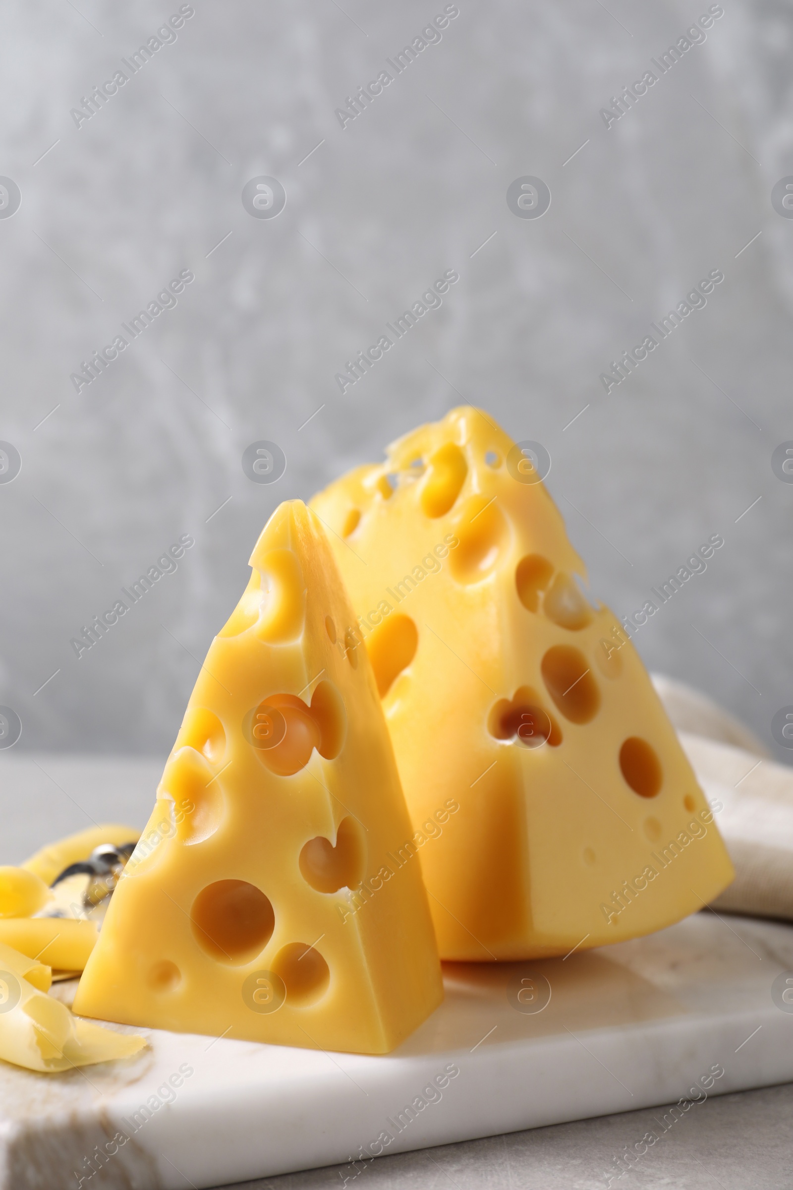 Photo of Tasty fresh cheese on white marble board, closeup