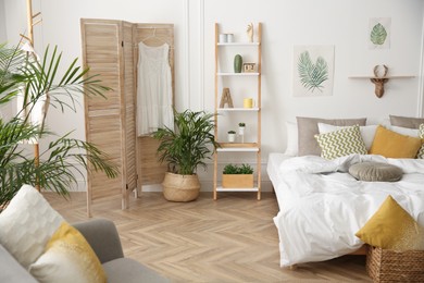 Modern bedroom with beautiful fresh house plants