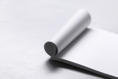 Photo of Blank paper sheets on grey textured table. Mockup for design