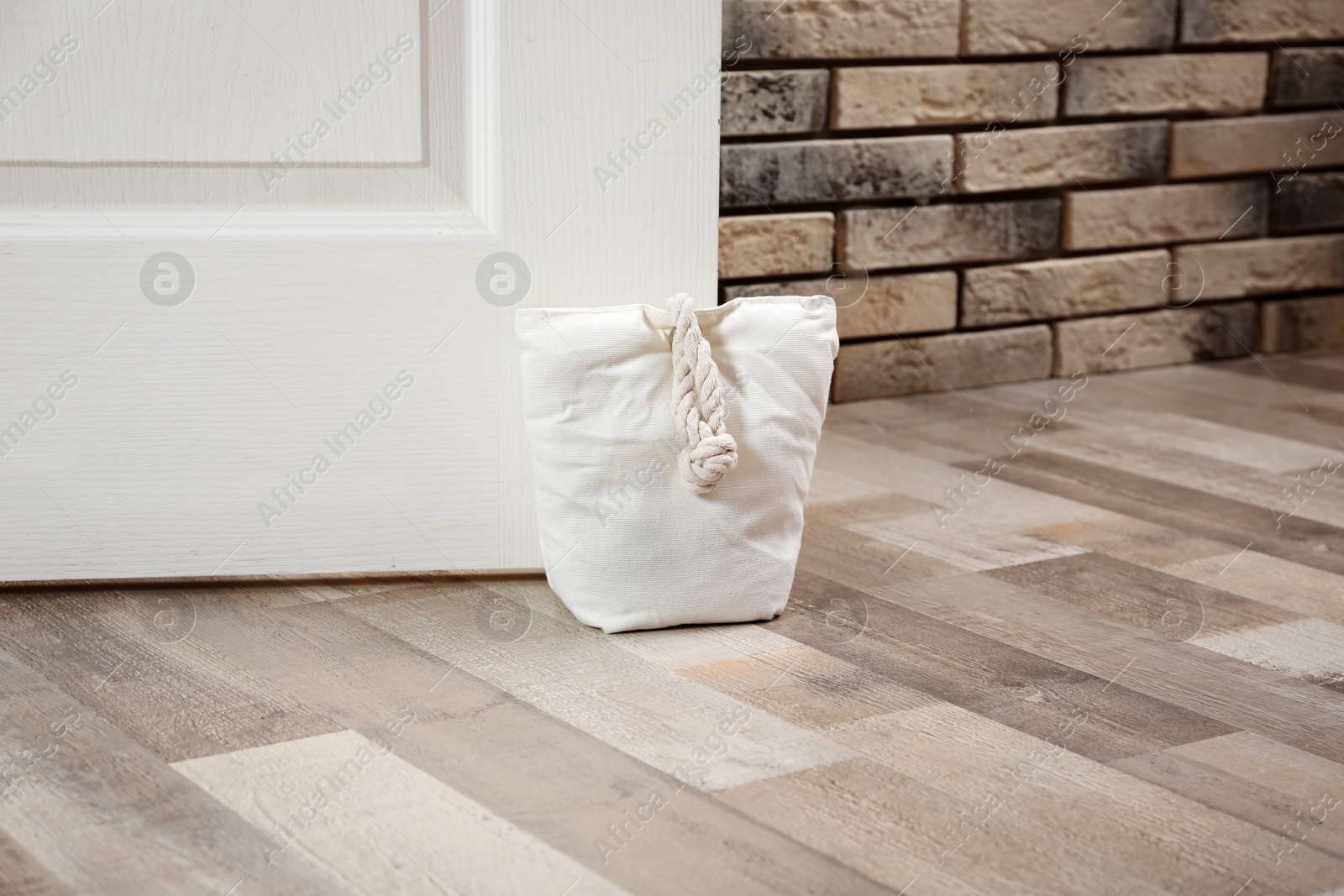 Stuffed bag holding wooden door at home Photo of Stuffed bag holding wooden door at home
