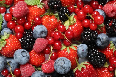 Photo of Mix of fresh delicious berries as background, top view