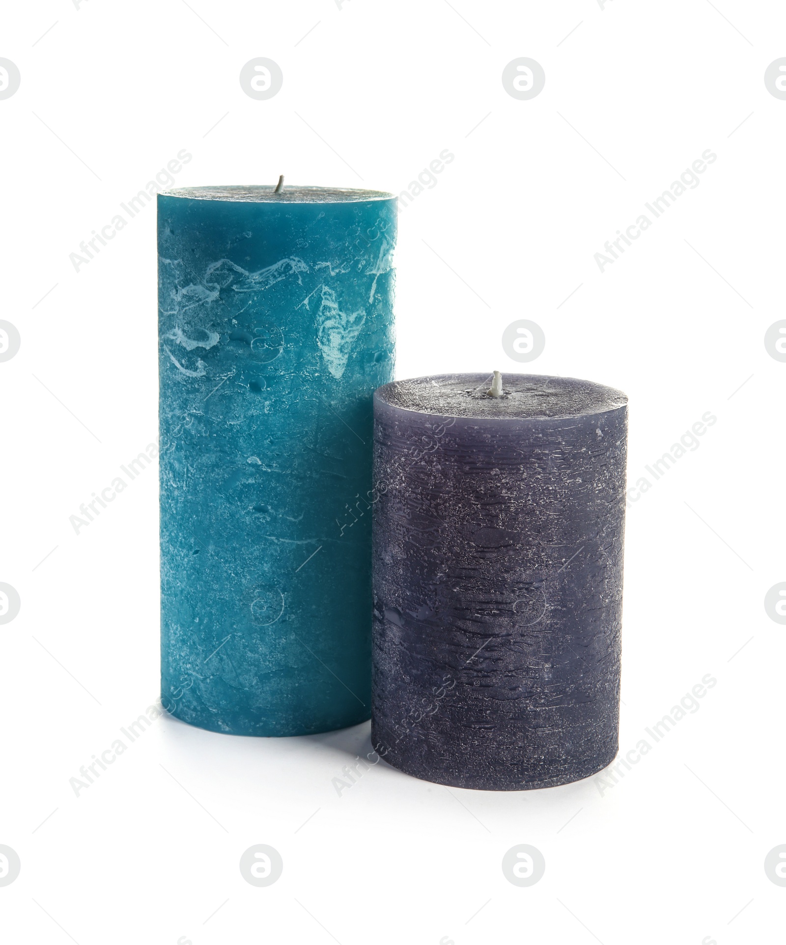 Photo of Two decorative wax candles on white background