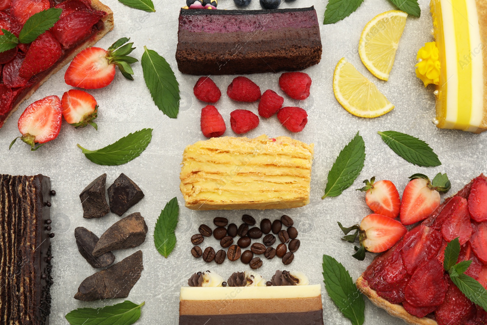 Photo of Flat lay composition with different tasty cakes on light grey table