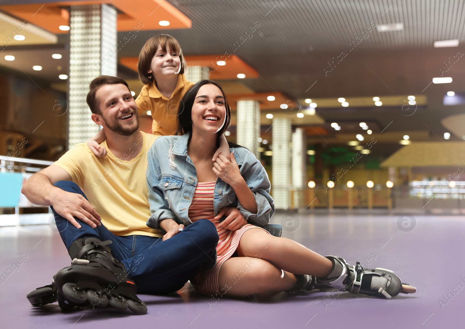 Photo of Happy family spending time at roller skating rink