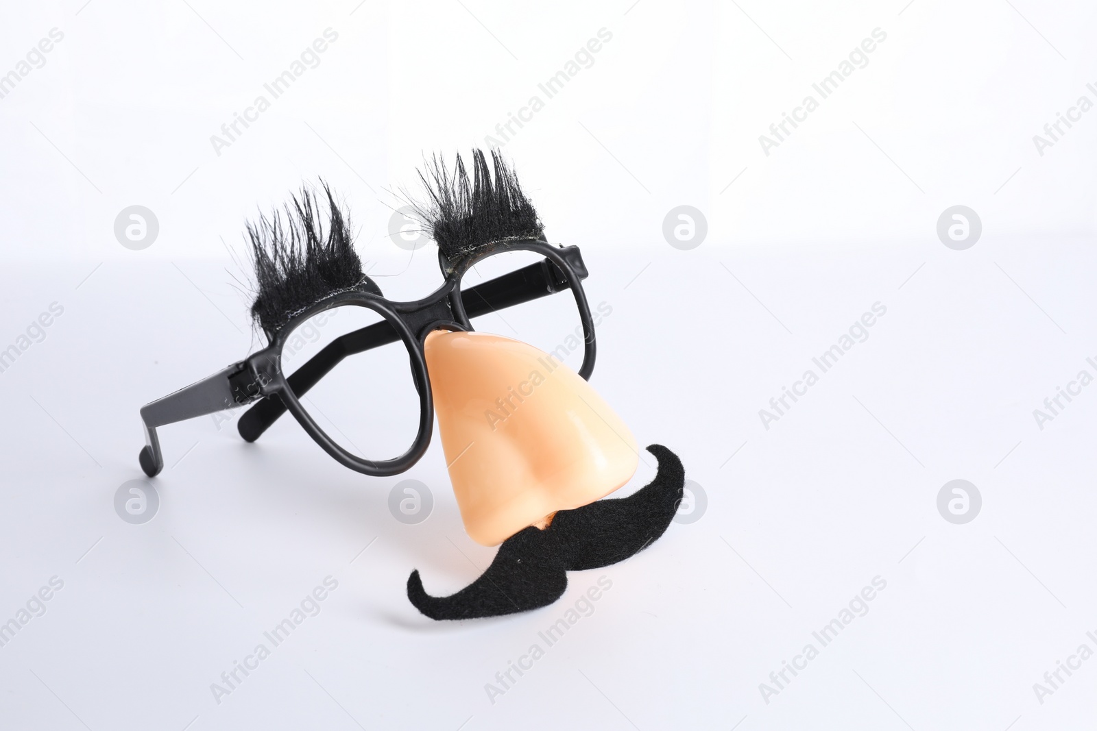 Photo of Funny mask with fake mustache, nose and glasses isolated on white