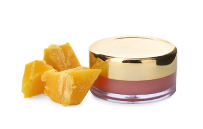 Photo of Lip balm and natural beeswax on white background