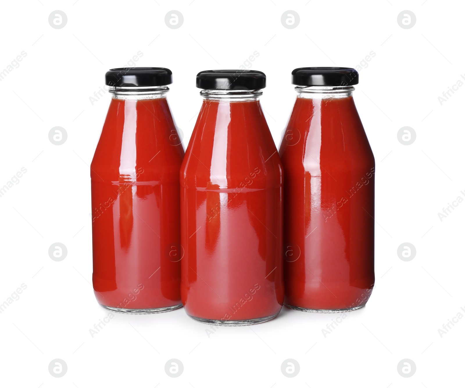 Photo of Bottles with tomato juice isolated on white
