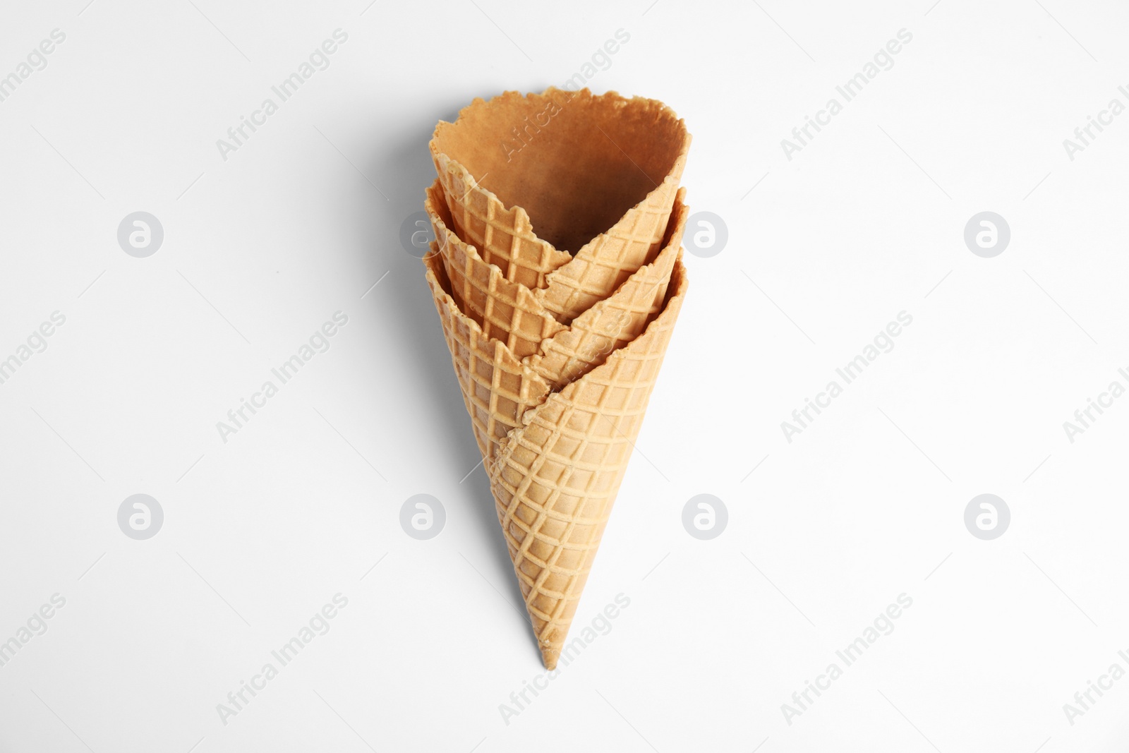 Photo of Empty wafer ice cream cones on white background, top view