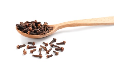 Photo of Aromatic dry cloves and wooden spoon on white background