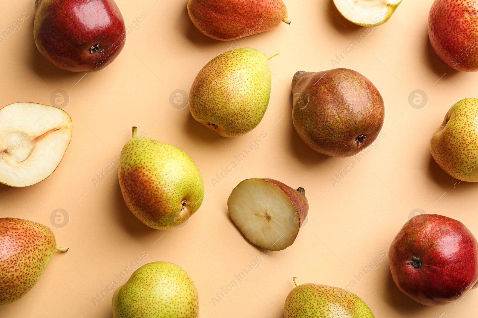 Photo of Ripe juicy pears on beige background, flat lay