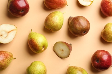 Ripe juicy pears on beige background, flat lay