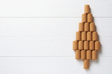 Christmas tree made of wine corks on white wooden table, top view. Space for text