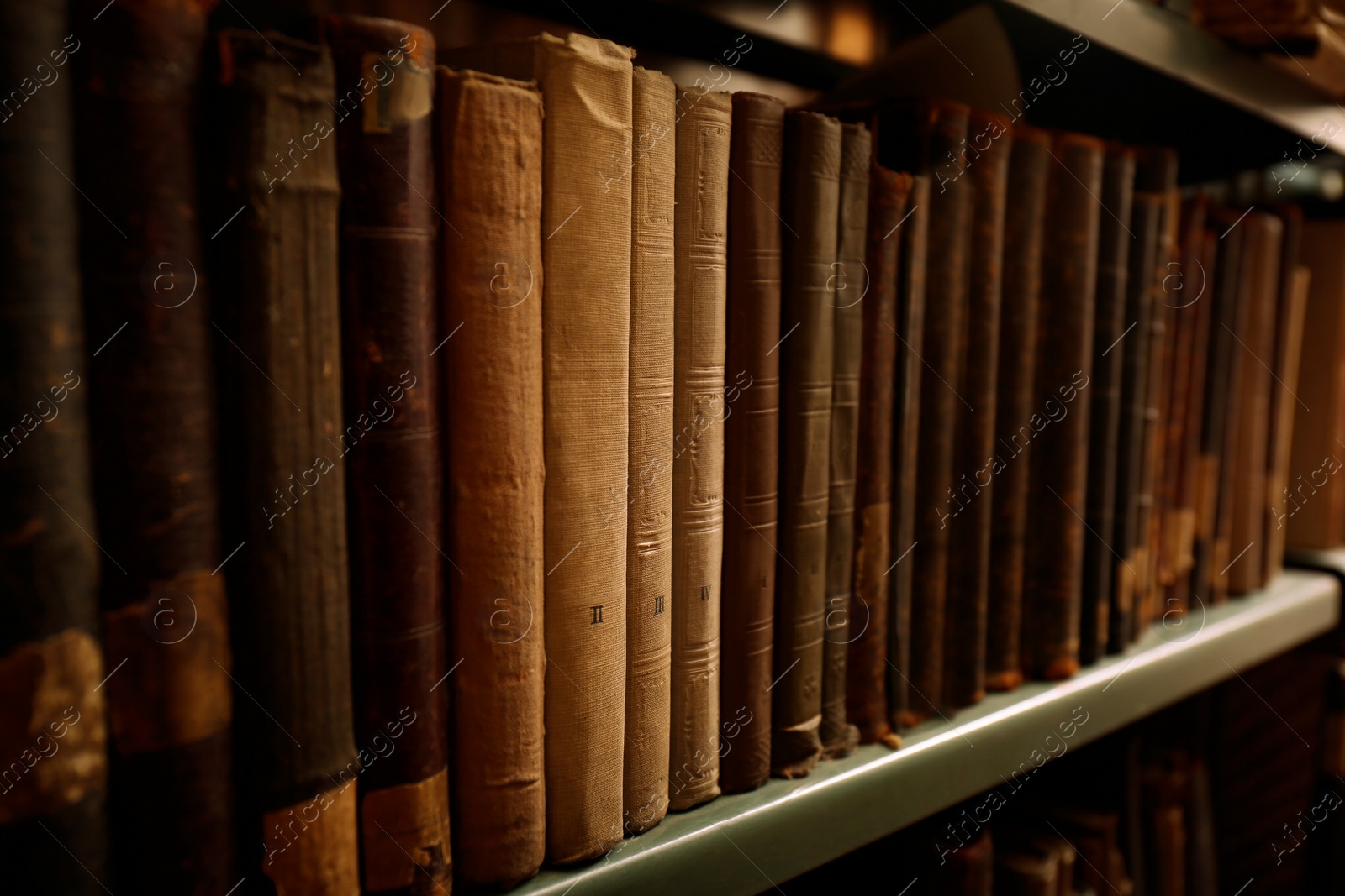 Image of Old books on shelf in library, closeup