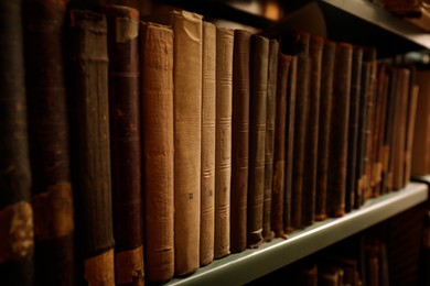 Image of Old books on shelf in library, closeup