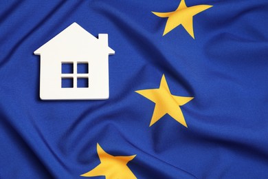 Photo of House model on flag of European Union, top view. Space for text