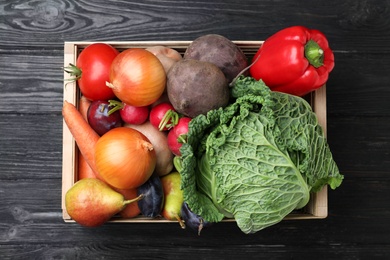 Photo of Crate full of different vegetables and fruits on black wooden table, top view. Harvesting time