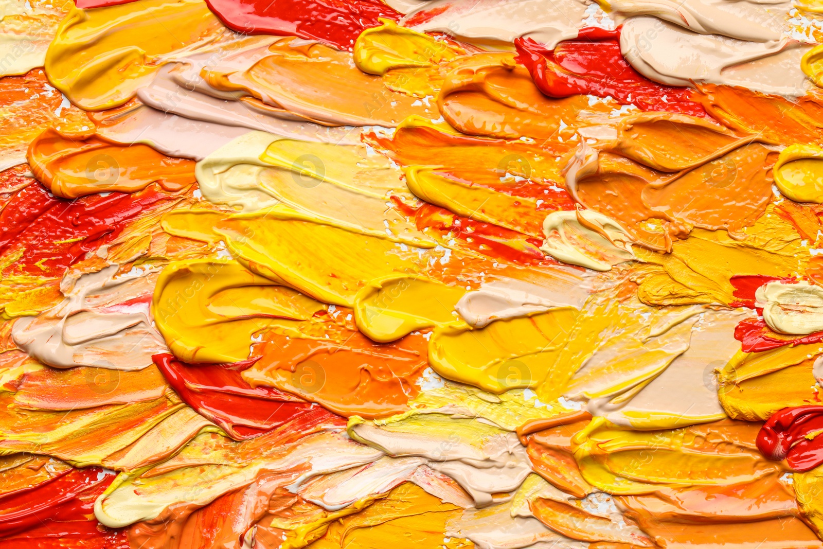 Photo of Beautiful strokes of colorful oil paints as background, closeup