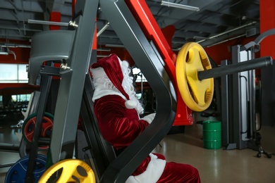 Photo of Authentic Santa Claus training in modern gym