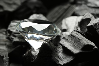 Beautiful shiny diamond on coals, closeup view