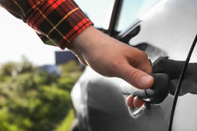 Closeup view of man opening car door