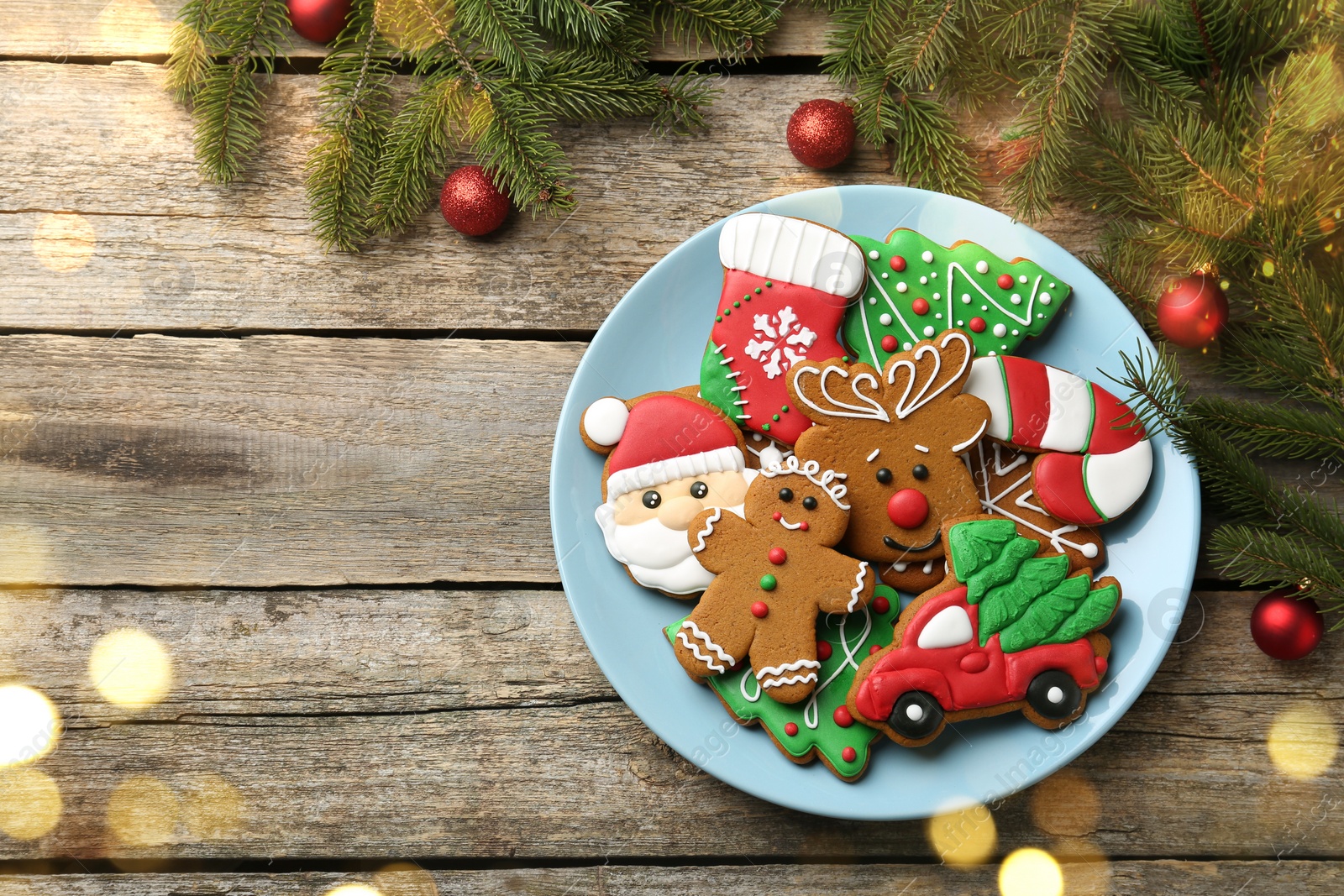 Photo of Different tasty Christmas cookies and decor on wooden table, flat lay. Space for text