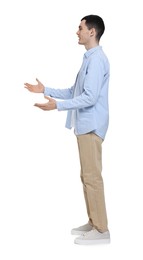 Photo of Young man in light blue shirt and beige pants on white background