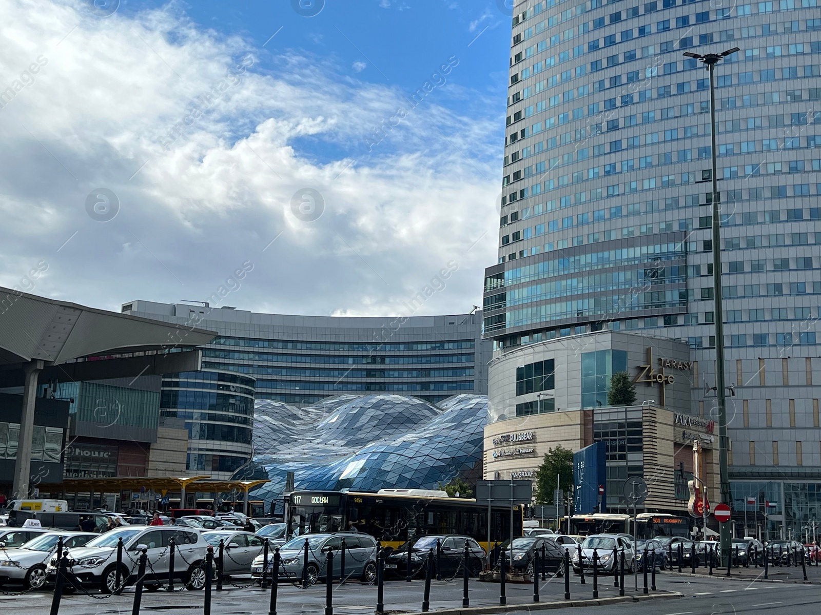 Photo of WARSAW, POLAND - JULY 17, 2022: View of shopping mall and parked cars outdoors