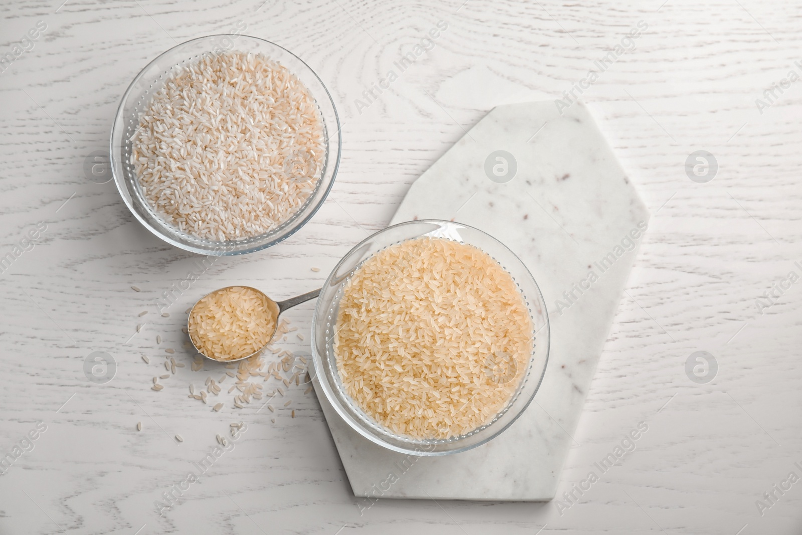 Photo of Flat lay composition with different types of rice on wooden table