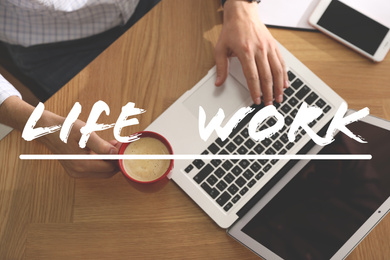 Image of Man with laptop at wooden table, closeup. Concept of balance between work and life