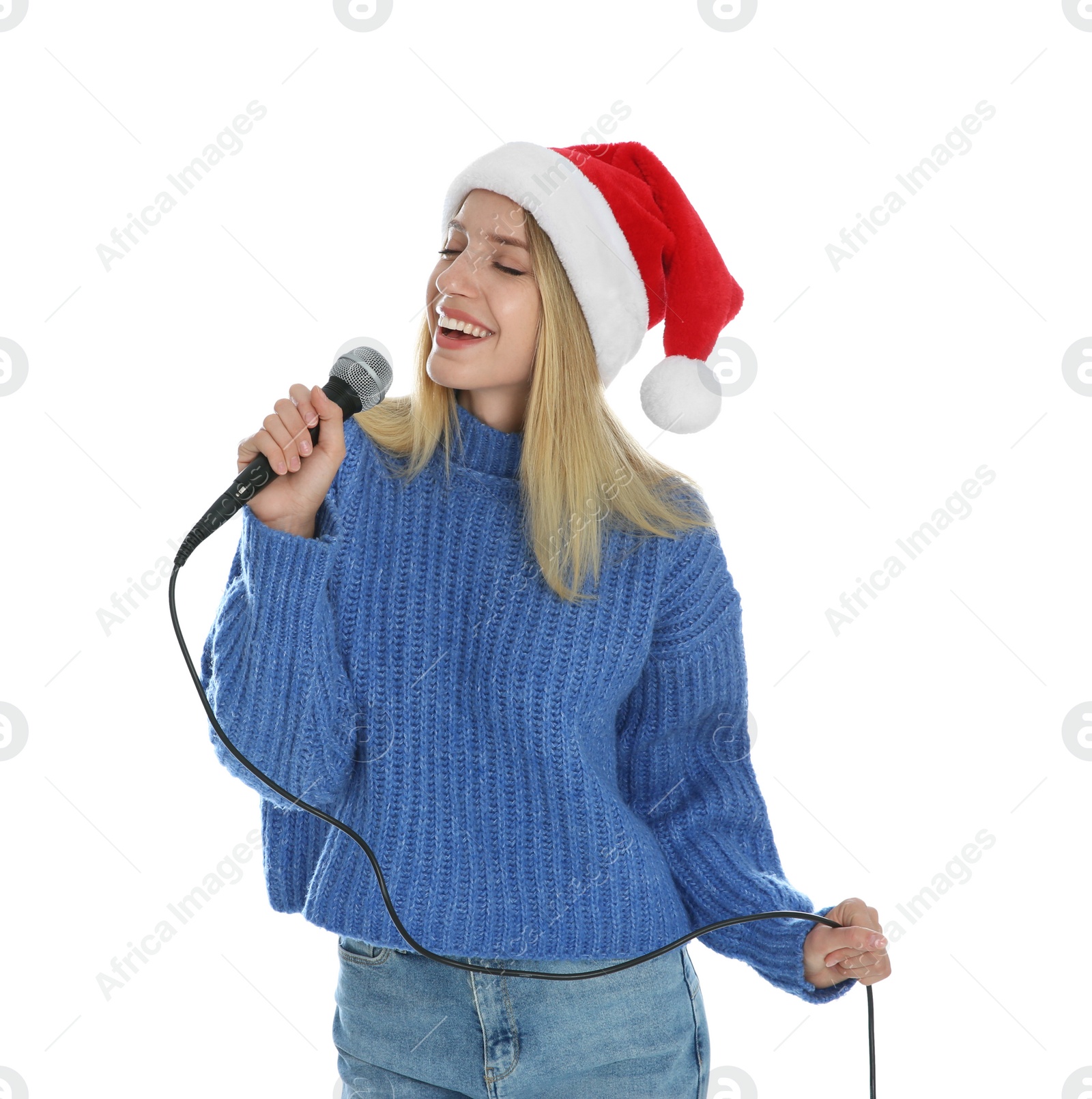 Photo of Happy woman in Santa Claus hat singing with microphone on white background. Christmas music