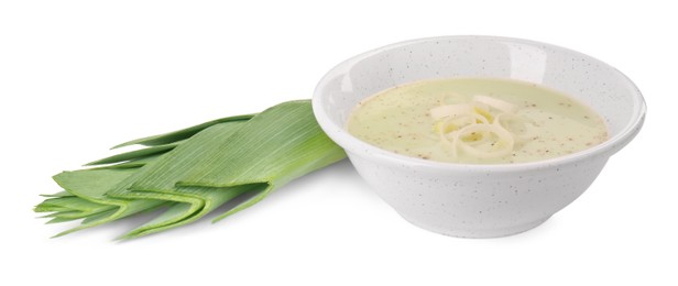 Photo of Bowl of tasty soup and fresh leek isolated on white
