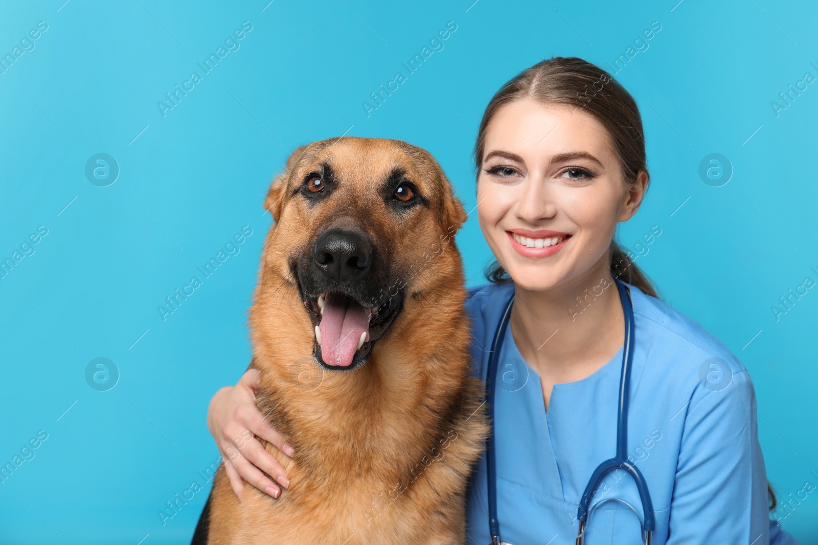 Photo of Veterinarian doc with dog on color background