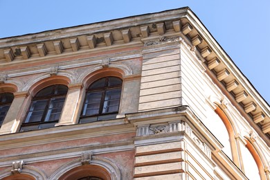 Photo of Beautiful building with windows against blue sky outdoors, low angle view