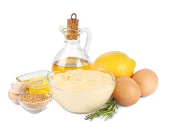 Glass bowl with fresh mayonnaise and ingredients on white background