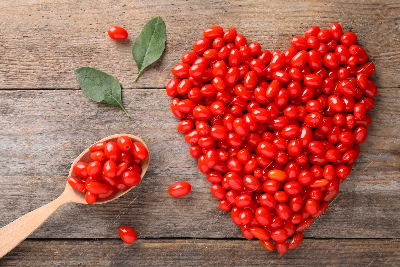 Photo of Flat lay composition with fresh ripe goji berries on wooden table