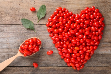 Photo of Flat lay composition with fresh ripe goji berries on wooden table