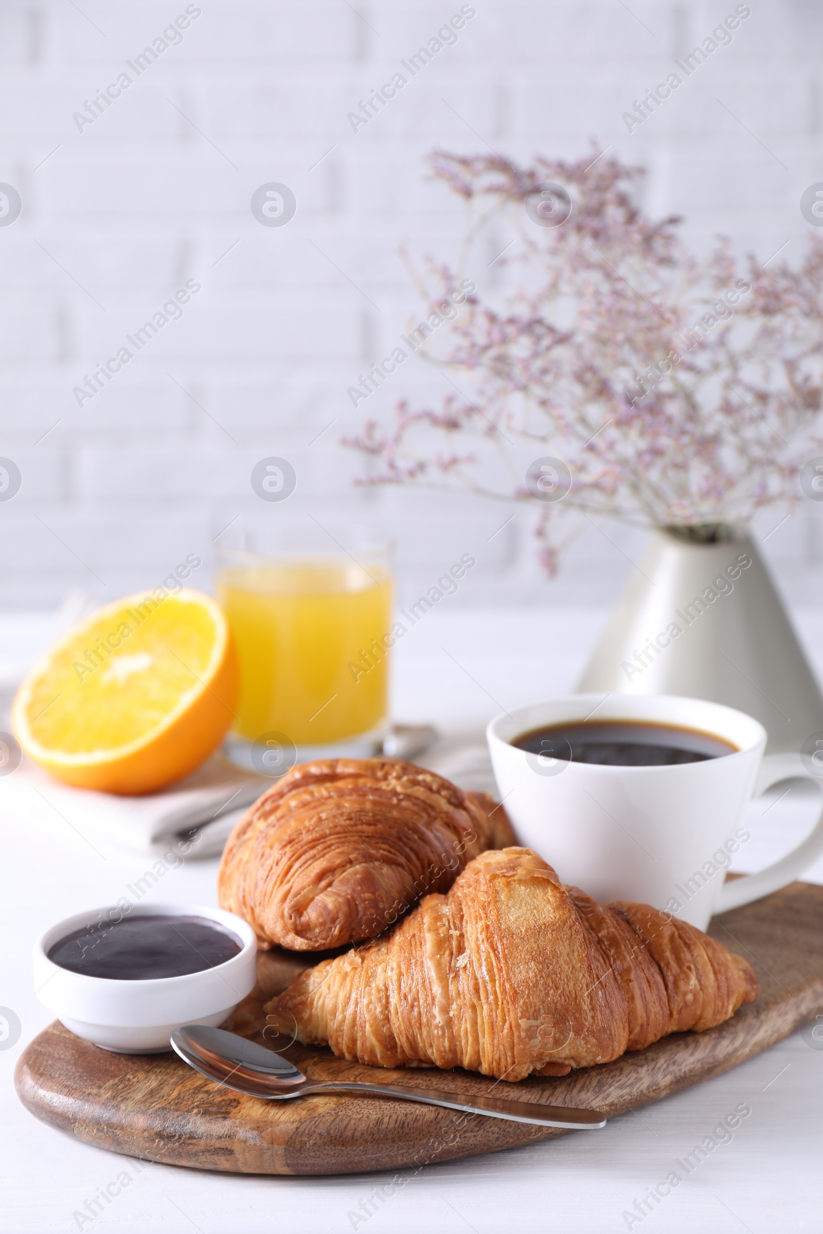 Tasty breakfast. Cup of coffee, jam and croissants on white wooden table Photo of Tasty breakfast. Cup of coffee, jam and croissants on white wooden table