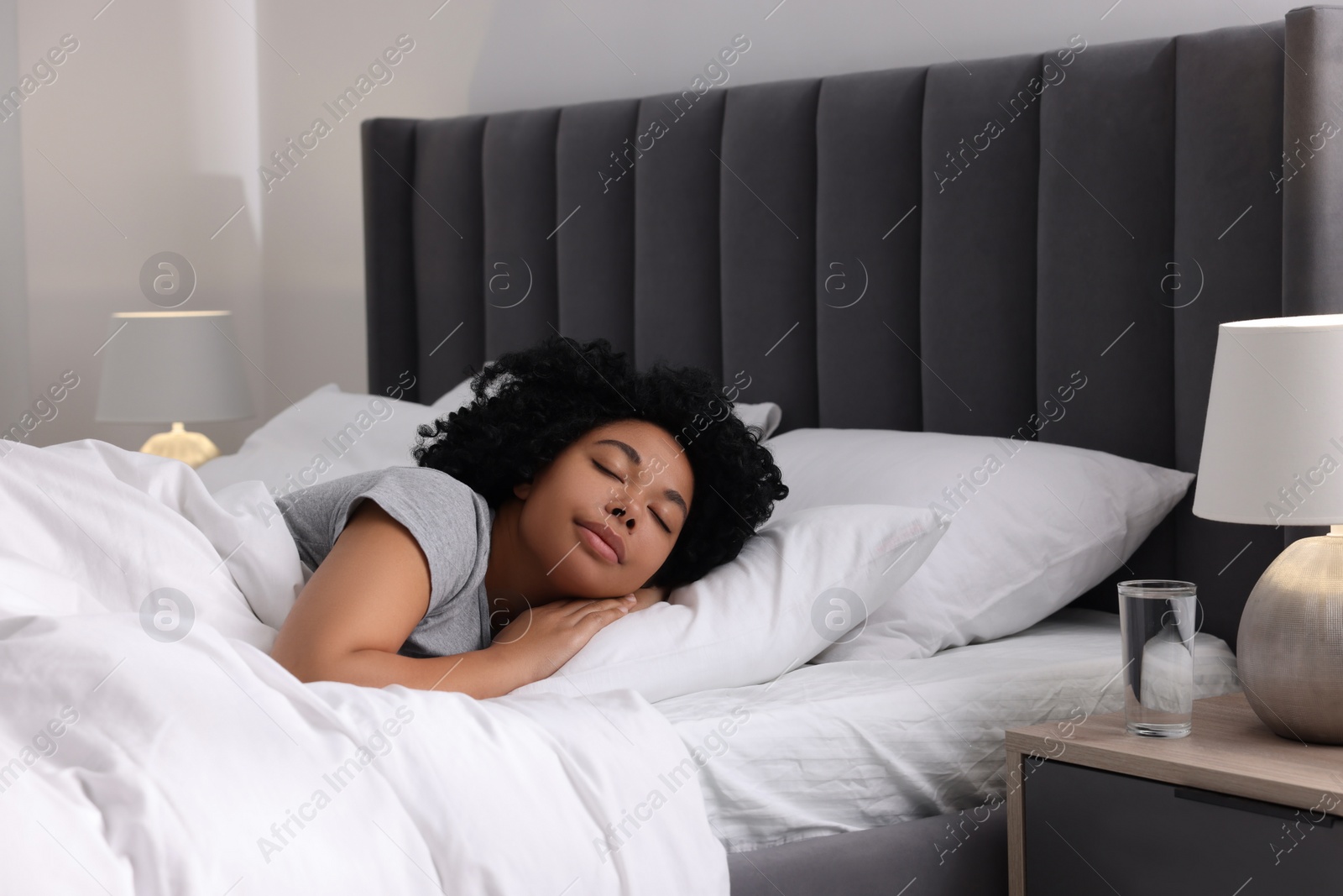 Photo of Beautiful young woman sleeping in soft bed at home