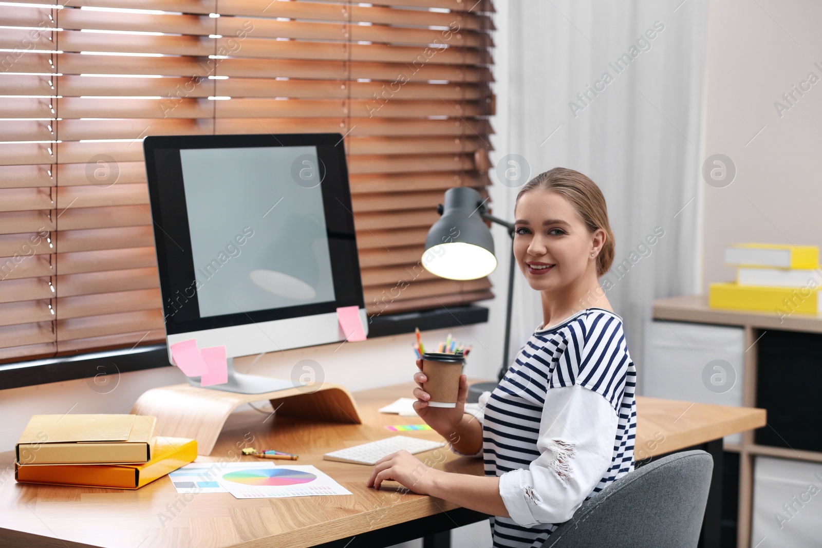 Photo of Female designer working at desk in office