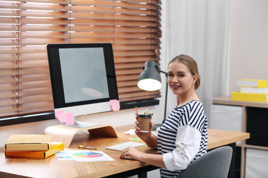 Photo of Female designer working at desk in office