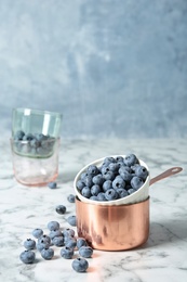 Photo of Cookware with juicy and fresh blueberries against blurred background