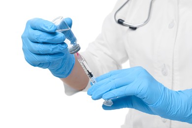 Photo of Doctor filling syringe with medication from glass vial on white background, closeup