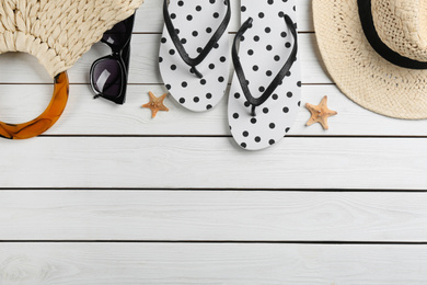 Photo of Flat lay composition with flip flops on white wooden background. Space for text