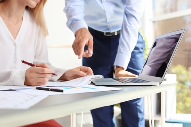 Tax accountants working with documents at table