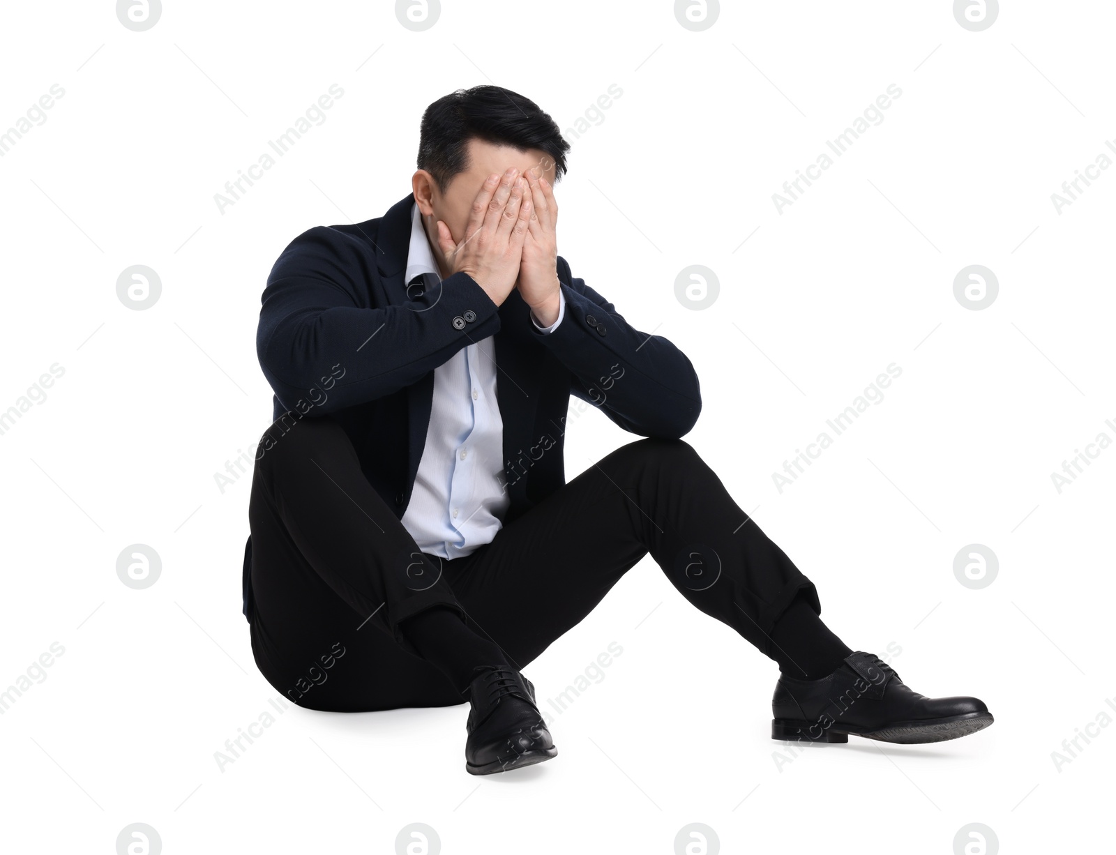 Photo of Tired businessman in suit sitting on white background