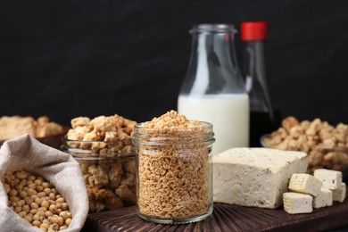 Photo of Different natural soy products on black table