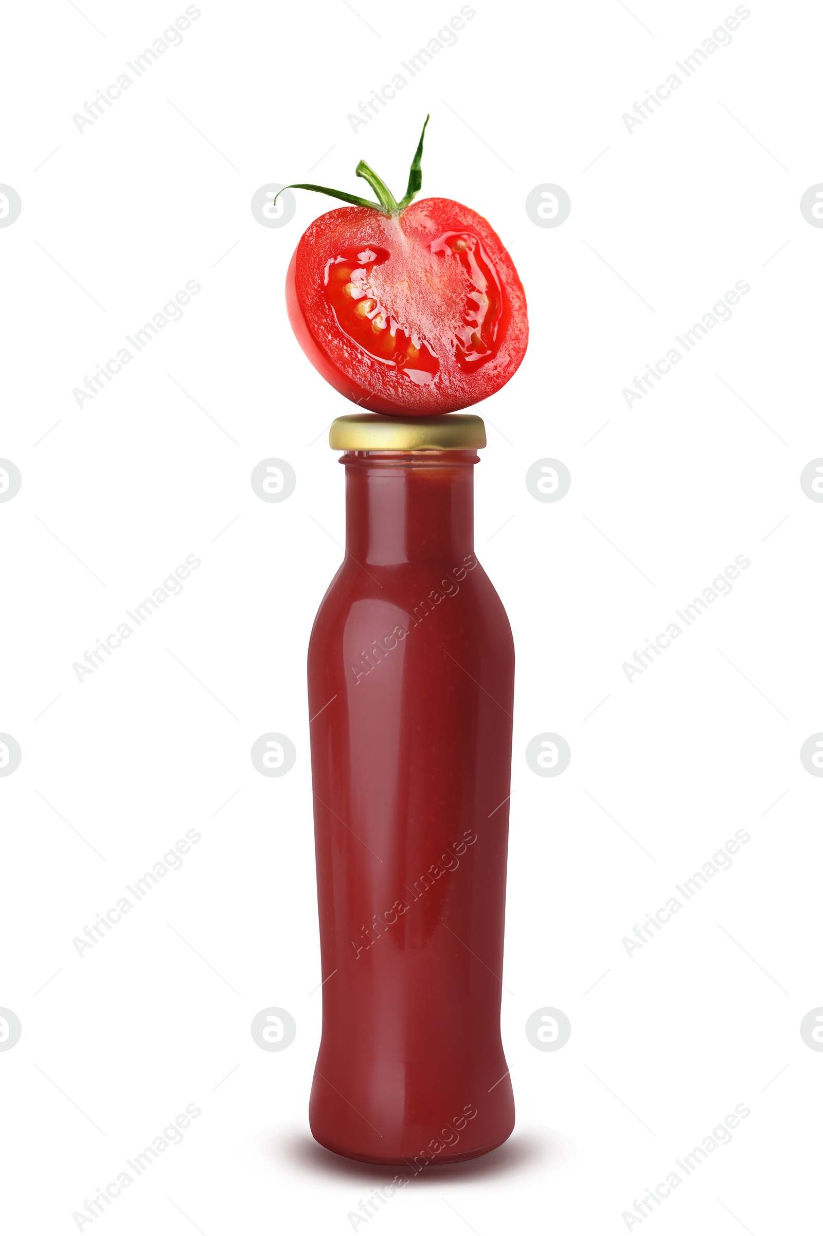 Image of Organic ketchup in glass bottle and cut tomato isolated on white