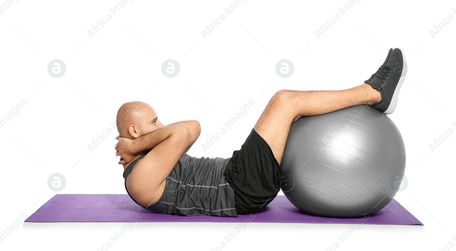 Photo of Overweight man doing exercise with fitness ball on white background