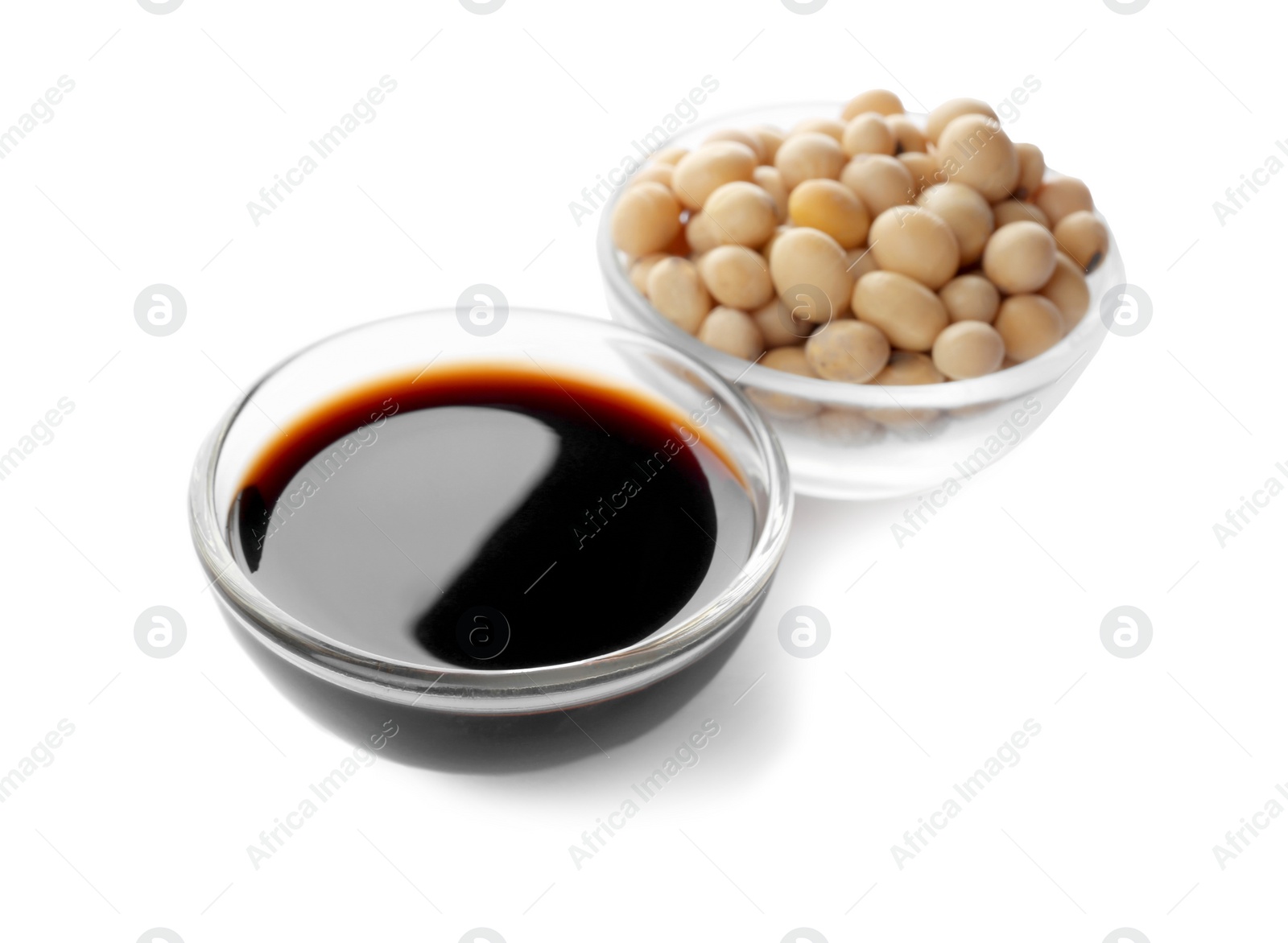 Photo of Bowl of tasty soy sauce and beans isolated on white